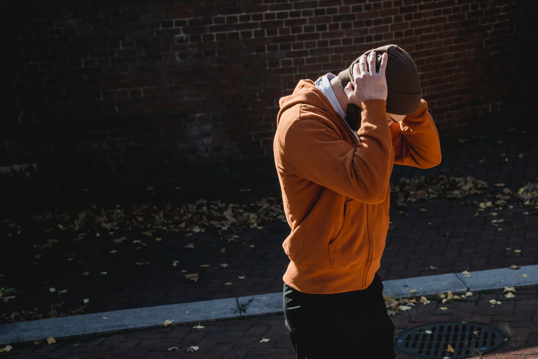 unrecognizable man with hands on head