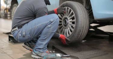 man changing a car tire