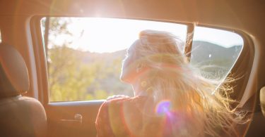 woman looking out of car window