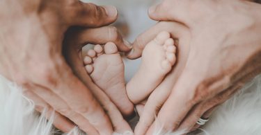 person holding baby s feet