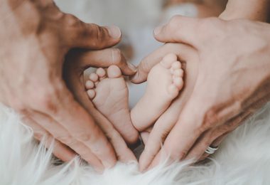 person holding baby s feet