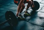 person holding barbell