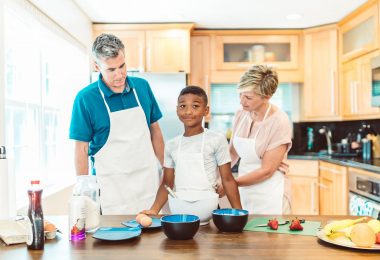 couple with their adopted child in the kitchen