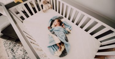 baby in blue blanket