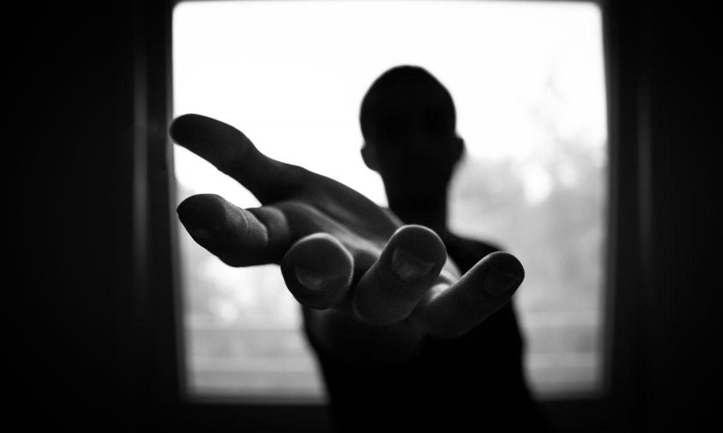 Man s hand in shallow focus and grayscale photography