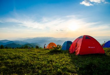 Photo of pitched dome tents overlooking mountain ranges