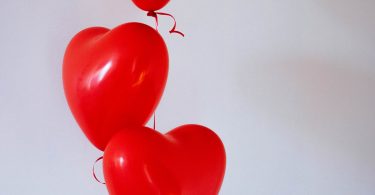 Three red heart balloons