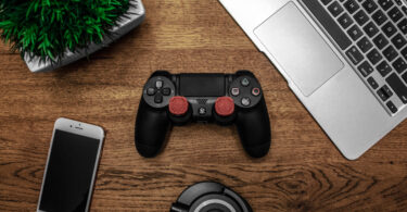 Black game console on wooden surface