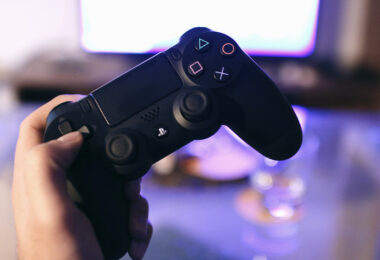 Person holding sony ps4 dualshock 4