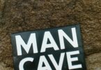 Man cave sign on rock