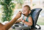 Photo of baby eating on a chair