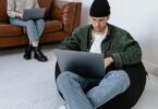 Man sitting on bean bag with laptop