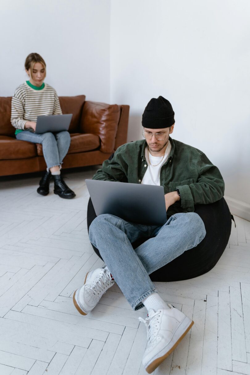 Man sitting on bean bag with laptop