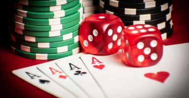 Poker hand with dice and chips in casino setting