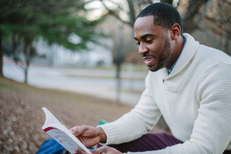 Man reading a book on manhood.